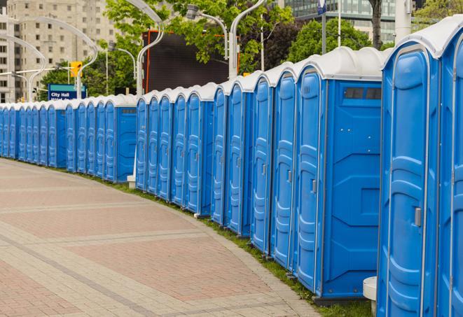 a line of portable restrooms at a sporting event, providing athletes and spectators with clean and accessible facilities in Attleboro Falls